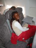 Nikki is trying to get comfortable on the Lauda Air flight